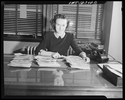 Detroit, Michigan. A box for suggestions from workers installed in the Cadillac motor car division of General Motors Corporation(?). Office worker with stacks of workers' suggestion