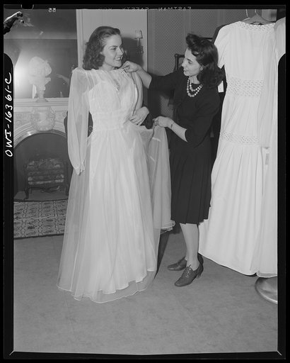 Detroit, Michigan. Fitting a dress at Saks Fifth Avenue store following a fashion show presented by the Chrysler Girls' Club of the Chrysler Corporation