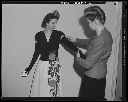 Untitled photo, possibly related to: Detroit, Michigan. Fitting a dress at Saks Fifth Avenue store following a fashion show presented by the Chrysler Girls' Club of the Chrysler Corporation