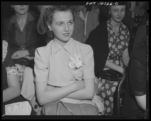 Detroit, Michigan. A Chrysler girl worker at Saks Fifth Avenue store following a fashion show presented by the Chrysler Girls' Club of the Chrysler Corporation