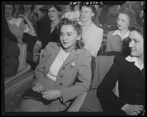 Detroit, Michigan. A Chrysler girl worker at Saks Fifth Avenue store following a fashion show presented by the Chrysler Girls' Club of the Chrysler Corporation