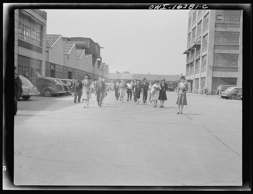 Detroit, Michigan. Girls and men coming out of the Highland Park Chrysler plant
