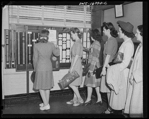 Detroit, Michigan. Office workers checking out at the Chrysler Corporation