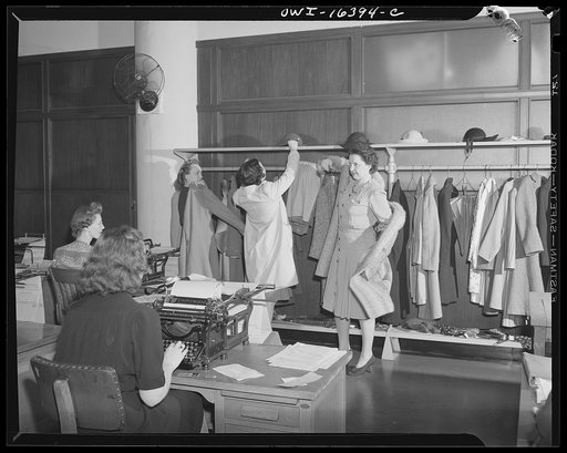 Detroit, Michigan. Office workers at the Chrysler Corporation putting on their coats
