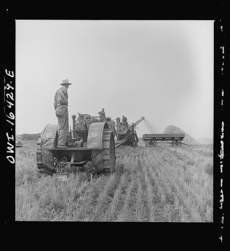 Untitled photo, possibly related to: Jackson, Michigan. Tractor which runs a threshing machine
