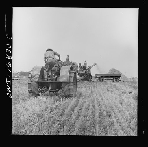 Untitled photo, possibly related to: Jackson, Michigan. Tractor which runs a threshing machine