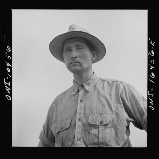 Untitled photo, possibly related to: Jackson, Michigan. Soldier, who was granted a furlough to help with the harvesting on this farm, watching threshing