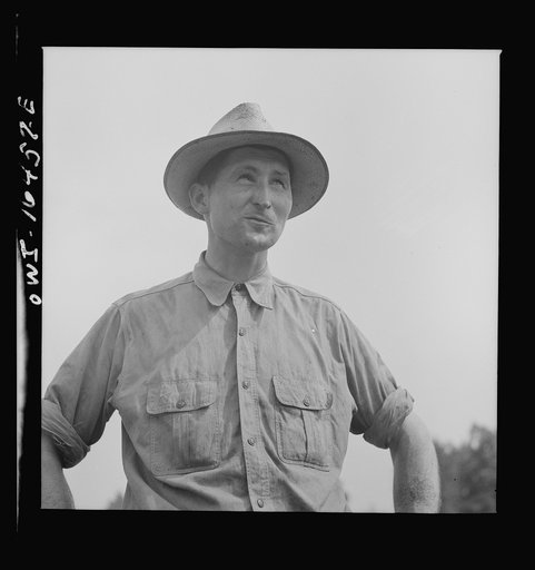 Untitled photo, possibly related to: Jackson, Michigan. Soldier, who was granted a furlough to help with the harvesting on this farm, watching threshing
