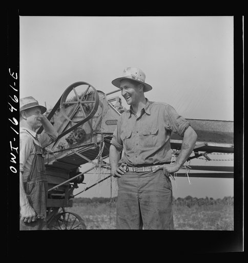 Untitled photo, possibly related to: Jackson, Michigan. Soldier who was granted a furlough to help with the harvesting on this farm, and farmer watching the threshing