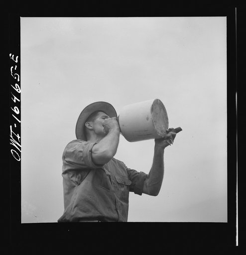 Jackson, Michigan. Drinking water from an earthenware crock
