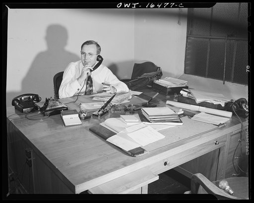 Untitled photo, possibly related to: Detroit, Michigan. Mr. Currier at his desk