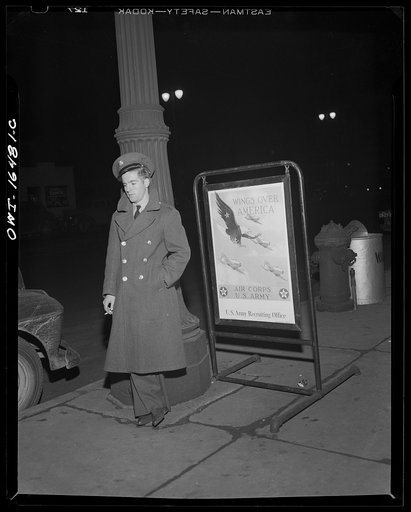 Detroit, Michigan. Lonely soldier and recruiting poster on New Year's Eve