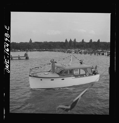 Detroit, Michigan. A Venetian night party at the Detroit yacht club, whose members represent the wealthier class of manufacturers and their friends. Small cabin cruiser