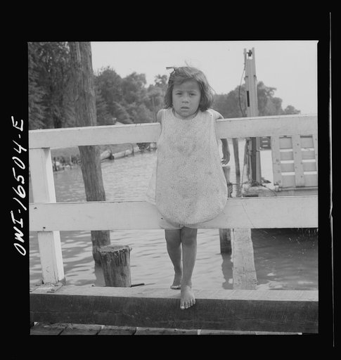 Untitled photo, possibly related to: Detroit, Michigan. A Venetian night party at the Detroit yacht club, whose members represent the wealthier class of manufacturers and their friends. Little girl at the entrance to the yacht club