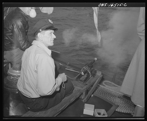 Detroit, Michigan. A Venetian night party at the Detroit yacht club, whose members represent the wealthier class of manufacturers and friends. Sailor with a small cannon used to salute boats
