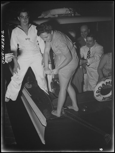 Untitled photo, possibly related to: Detroit, Michigan. A Venetian night part at the Detroit yacht club, whose members represent the wealthier class of manufacturers and their friends. Girl with clothing swimming