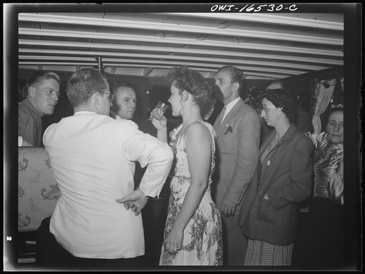 Untitled photo, possibly related to: Detroit, Michigan. A Venetian night party at the Detroit yacht club, whose members represent the wealthier class of manufacturers and their friends. Couple kissing in a boat