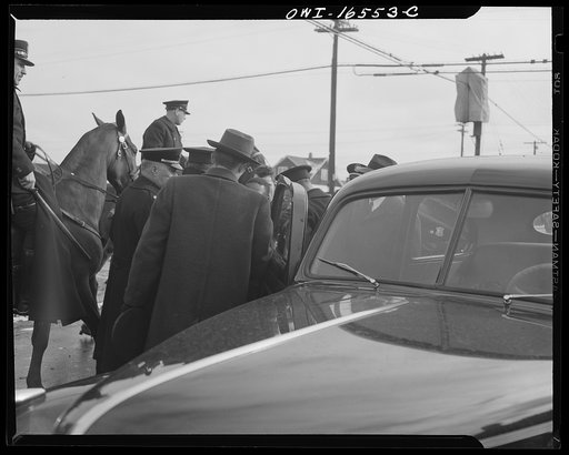 Untitled photo, possibly related to: Detroit, Michigan. Riot at the Sojourner Truth homes, a new U.S. federal housing project, caused by white neighbors' attempt to prevent Negro tenants from moving in. Police arresting a Negro