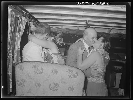Detroit, Michigan. A Venetian night party at the Detroit yacht club, whose members represent the wealthier class of manufacturers and their friends. Couple kissing in a boat