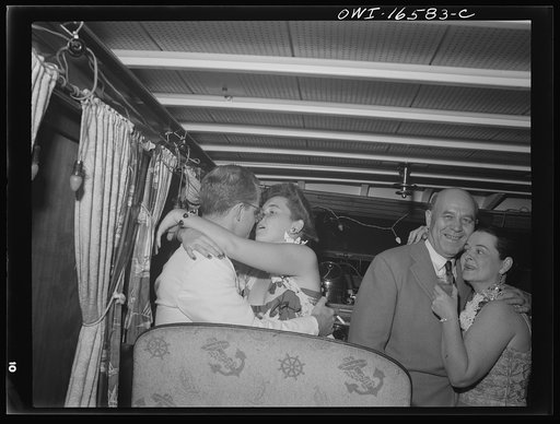 Untitled photo, possibly related to: Detroit, Michigan. A Venetian night party at the Detroit yacht club, whose members represent the wealthier class of manufacturers and their friends. Couple kissing in a boat