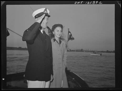 Untitled photo, possibly related to: Detroit, Michigan. A Venetian night party at the Detroit yacht club, whose members represent the wealthier class of manufacturers and their friends. The Commodore with a girl, reviewing the fleet