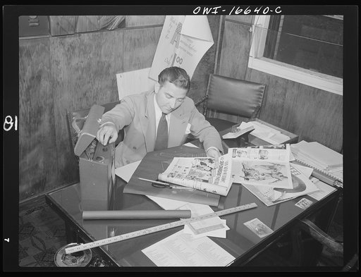 Untitled photo, possibly related to: Detroit, Michigan. Head of the art department with new model at the Crowley-Milner department store.