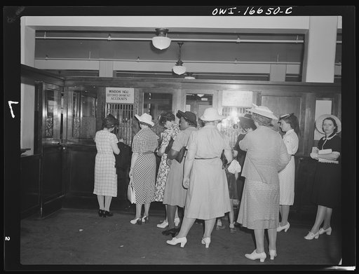 Detroit, Michigan. Women paying bills at the charge account window at the Crowley-Milner department store