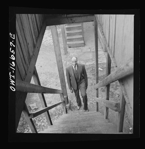 Detroit, Michigan. Coming up the stairway to a Negro's home. These are conditions under which families originally lived before moving to the Sojourner Truth housing project