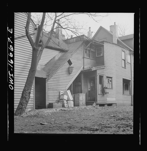 Detroit, Michigan. Seven Negro families live in this di lapidated house. These are conditions under which families originally lived before moving to the Sojourner Truth housing project