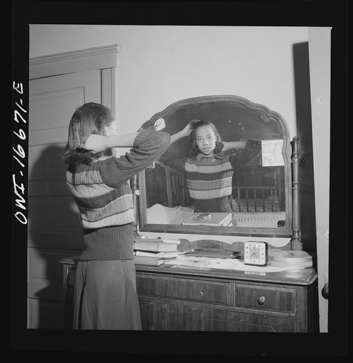 Detroit, Michigan. Negro girl putting up her hair