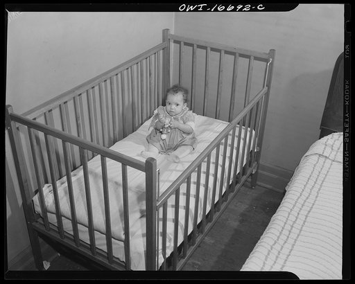 Detroit, Michigan. Negro baby in a crib. These are conditions under which families originally lived before moving to the Sojourner Truth housing project