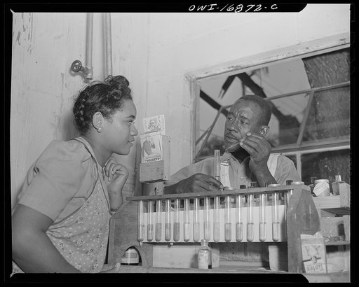 Daytona Beach, Florida. Bethune-Cookman College. Mr. Mills, supervisor of the school laundry, showing a student chemicals used in different cleaning processes