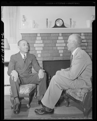 Winter Park, Florida. Mr. James A. Colston, youthful president of Bethune-Cookman College, talking with his father about the administrative problems