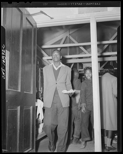 Daytona Beach, Florida. Bethune-Cookman College. Student entering the dining-hall with a plate lunch given to him in the cafeteria kitchen
