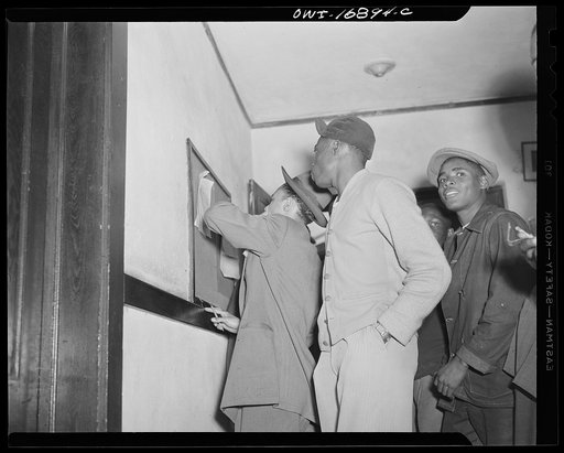 Daytona Beach, Florida. Bethune-Cookman College. NYA (National Youth Administration) students who live in the regular school dormitory looking at class schedule