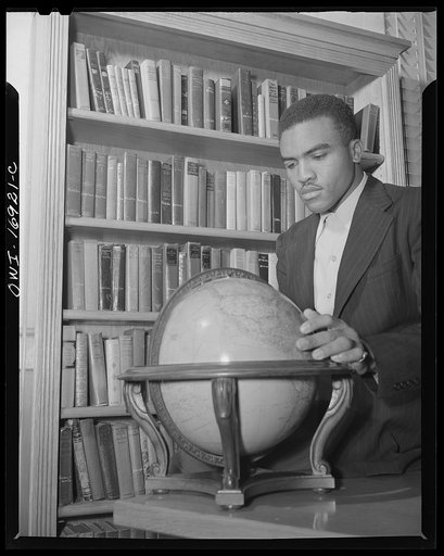 Daytona Beach, Florida. Bethune-Cookman College. A student studying the world globe in the library