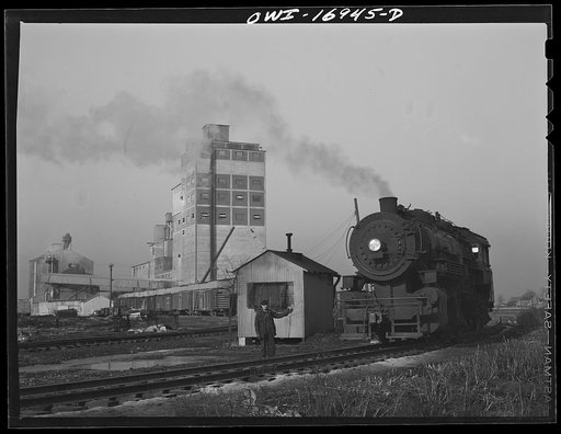 Untitled photo, possibly related to: Blue Island, Illinois. Daniel Senise at his job at an Indiana Harbor Belt Line railroad yard. In the background is the Arcady Milling Company to which he makes many deliveries