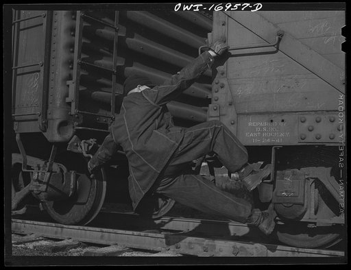 Daniel Senise releasing a pin on a moving car at work in an Indiana Harbor Belt Line railroad yard