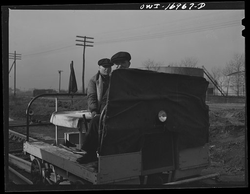 Untitled photo, possibly related to: Members of a section crew riding a hand car at an Indiana Harbor Belt Line railroad yard