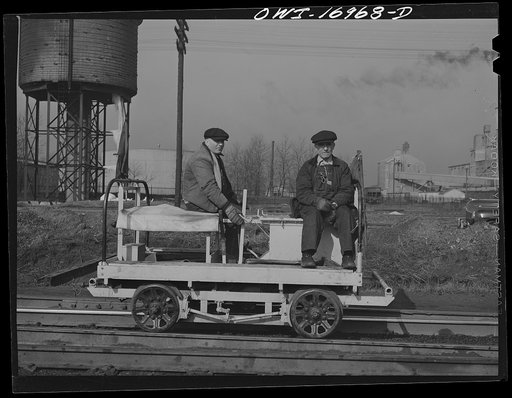 Members of a section crew riding a hand car at an Indiana Harbor Belt Line railroad yard