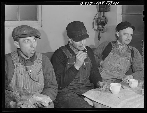 Daniel Senise at lunch in the work shanty at an Indiana Harbor Belt Line railroad yard. With him are (left) switchman John McCarthy and (right) switchman E.H. Alrecht