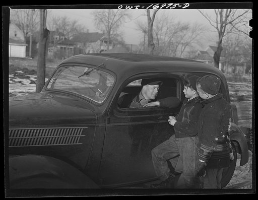 Blue Island, Illinois. Daniel Senise is greeted by his son Bobby and his friend as he comes home from work. The "A" gasoline ration is just about enough for him to get to and from work and do some shopping once a week