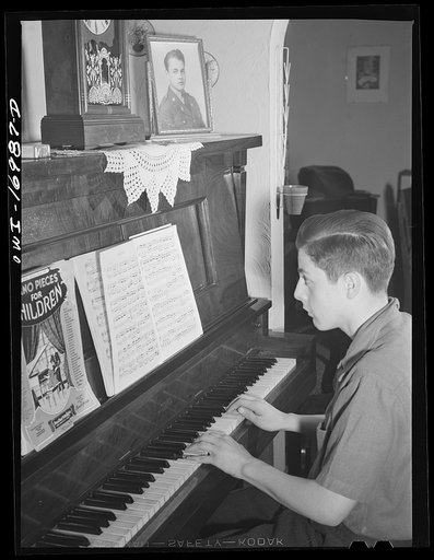 Blue Island, Illinois. Jerry Senise takes piano lessons and "bangs" around whenever he has time. On the piano is a picture of his brother Jack, who is in the U.S. Army and just returned from Hawaii