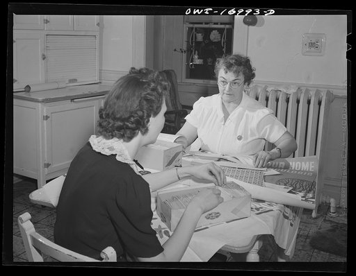 Blue Island, Illinois. Mrs. Senise was a chairman of the Christmas seal drive for the tuberculosis campaign. She is working on her accounts with the help of a friend