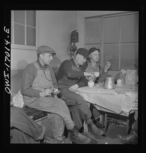 Daniel Senise at lunch in the work shanty at an Indiana Harbor Belt Line railroad yard. With him are (left) switchman John McCarthy and (right) switchman E.H. Albrecht