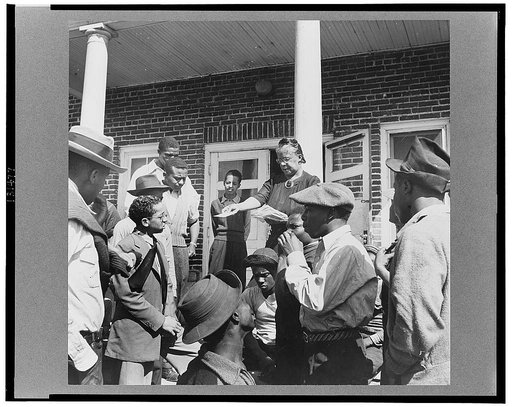 Daytona Beach, Florida. Bethune-Cookman College. Mrs. Shaw handing out mail to college and NYA (National Youth Administration) students in front of the boys' dormitory