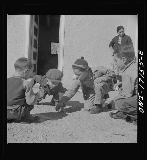 Untitled photo, possibly related to: Trampas, New Mexico. Playing marbles in the dooryard of the home of Juan Lopez, the majordomo (mayor) [i.e., steward