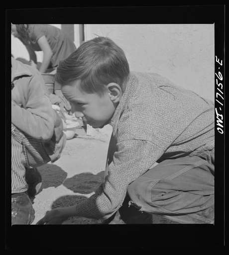 Untitled photo, possibly related to: Trampas, New Mexico. Playing marbles in the dooryard of the home of Juan Lopez, the majordomo (mayor) [i.e., steward
