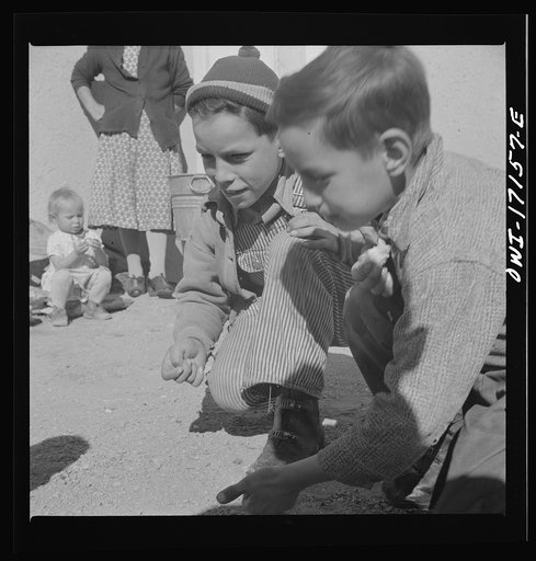 Untitled photo, possibly related to: Trampas, New Mexico. Playing marbles in the dooryard of the home of Juan Lopez, the majordomo (mayor) [i.e., steward