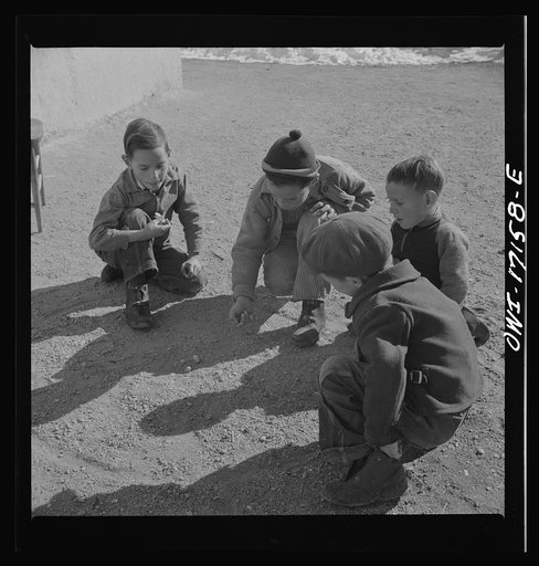 Trampas, New Mexico. Playing marbles in the dooryard of the home of Juan Lopez, the majordomo (mayor) [i.e., steward
